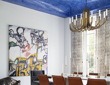 Large dining room with seating for ten. Magnificent blue ceiling and modern painting on the wall in Houston, TX